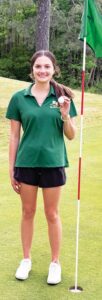 PUT HER DOWN FOR ‘1’ Kenston sophomore Kelsey Carter holed her teeshot Thursday on the par-3 second hole at Providence Golf Club in Richmond.