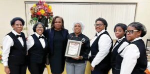 Order In The Court Elite Catering, owned and operated by Blackstone native Spring Henderson-Neal (center, with plaque), was selected by Brunswick County to cater a reception for State Supreme Court Justice Cleo E. Powell. A Brunswick native, Justice Powell on Jan. 1st will become the high court’s first Black Chief Justice. FROM LEFT: Brenda Hicks (Spring’s mother), Demetria Johnson, Justice Powell, Mrs. Henderson-Neal, Lakeshia Barnes, Teasia Barnes, and Twalla Moore.