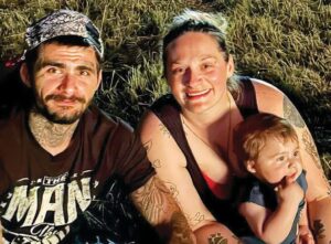 RT. 40 TRAGEDY Accident survivor Julie Boyd, 30, is shown here in July 4th photo with her boyfriend, the late Cody Peyton, who was fatally injured in July 28th crash. Also shown is their son, Julian Michael Peyton, who turned 1 just days after Cody died and while Julie was fighting for her life in Chippenham Medical Center.