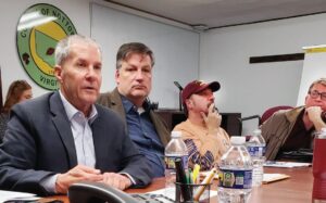 Bumper-To-Bumper Ward Burton (left) makes point during Dec. 29th meeting of the Nottoway Board of Supervisors and the County’s Economic Development Committee, held in the Health Department basement which serves as the County’s Emergency Operations Center (EOC). Also shown are Tom Inge, Executive Director of the Ward Burton Wildlife Foundation, Supervisor John Roark preparing “track strategy,” and County Administrator Steve Bowen. Burton is a native Southside Virginian who won the Daytona 500 in 2002. He’s well-known in this area and served as Blackstone’s Christmas Parade Grand Marshal in 2021. Blackstone Mayor Lafayette Dickens (not shown) was among the officials present and, during the meeting, captured this image, which he posted on his Mayor of Blackstone VA Facebook page.
