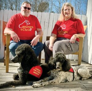 Spreading The Word As members of Canines 4 Christ, Tom & Cheryl Reynolds of Nottoway County and their poodles, Ash and Grace, regularly visit Piedmont Geriatric Hospital, Central State Hospital, and Hickory Hill Retirement Community. Photo by Tomi Woodward