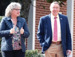 Post-Ruling Reaction School Board member Bill Outlaw (right) appeared in good spirits Wednesday with wife Laura while leaving court after a judge ruled in favor of rival Chris Page.