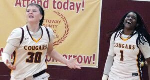Ice In Her Veins Nottoway Lady Cougar freshman Alex Shelton (left) celebrates her late game threepointer as teammate Janaria Stokes (#1) smiles in jubilation. Nottoway’s JV girls beat Central of Lunenburg, 36-32, in James River District Championship game Wednesday.