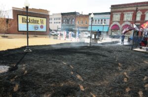 EXTRA HOT This was the scene Friday afternoon in the Town Square after suspected sparks from a smoker ignited dormant grass. Incident occurred one day shy of one-year anniversary of similar incident last year.