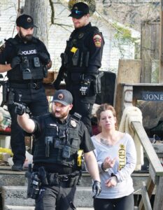 This Way, Ma’am Blackstone Police Cpl. Jeremy Ruppert (left) leads 5th Street resident Becky Lea Thompson to waiting patrol car after Saturday morning search warrant was executed at her apartment. A Crewe man identified as Buck Edward Joy also was arrested in Sarturday’s 5th Street raid.